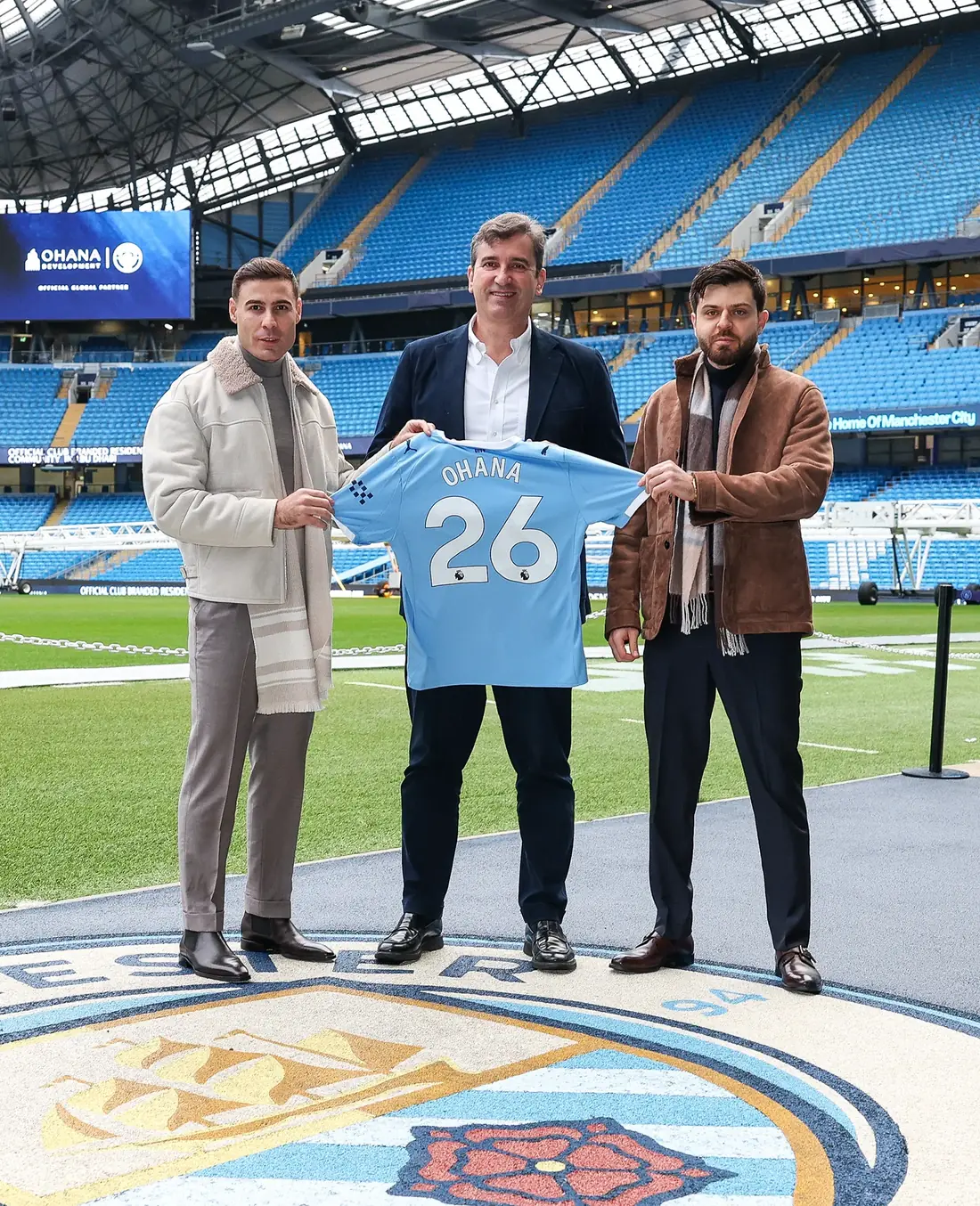Ohana Development leadership with a Manchester City shirt at the Etihad Stadium